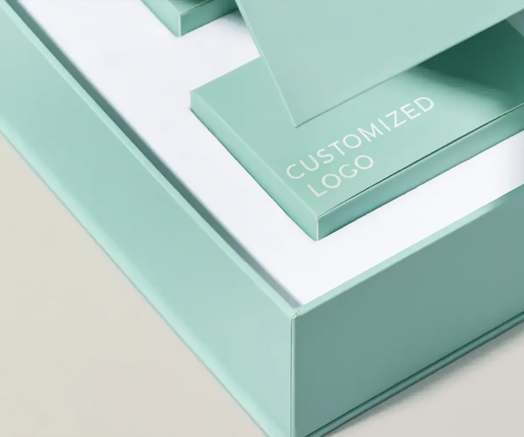 Custom luxury cosmetics packaging box in pastel green with compartments and printed logo.