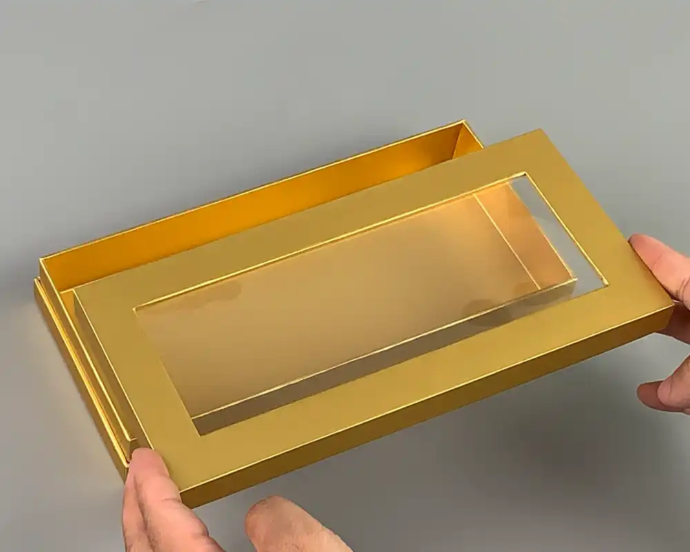 Golden two-piece packaging box with transparent window customization.