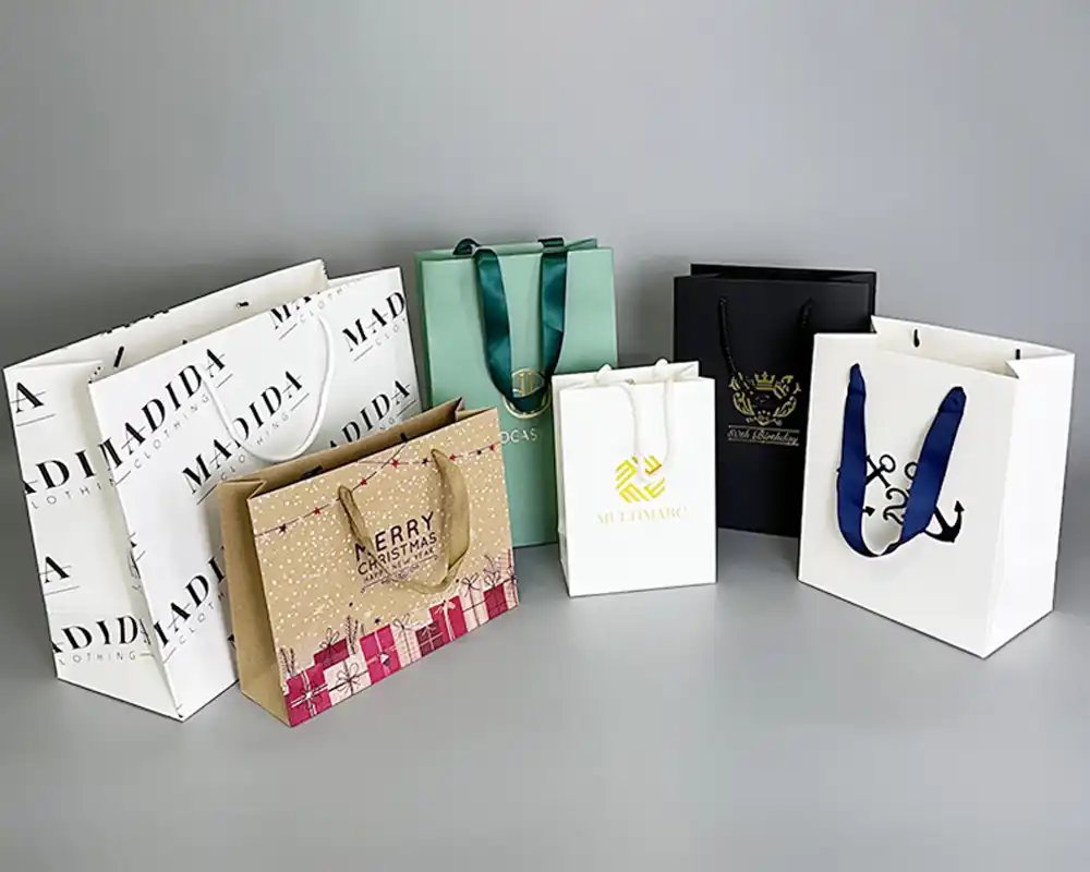 Assorted custom paper bags with different prints, logos, and handles.
