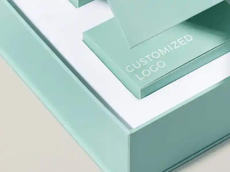 Close-up of a mint green rigid box with customized logo printing.