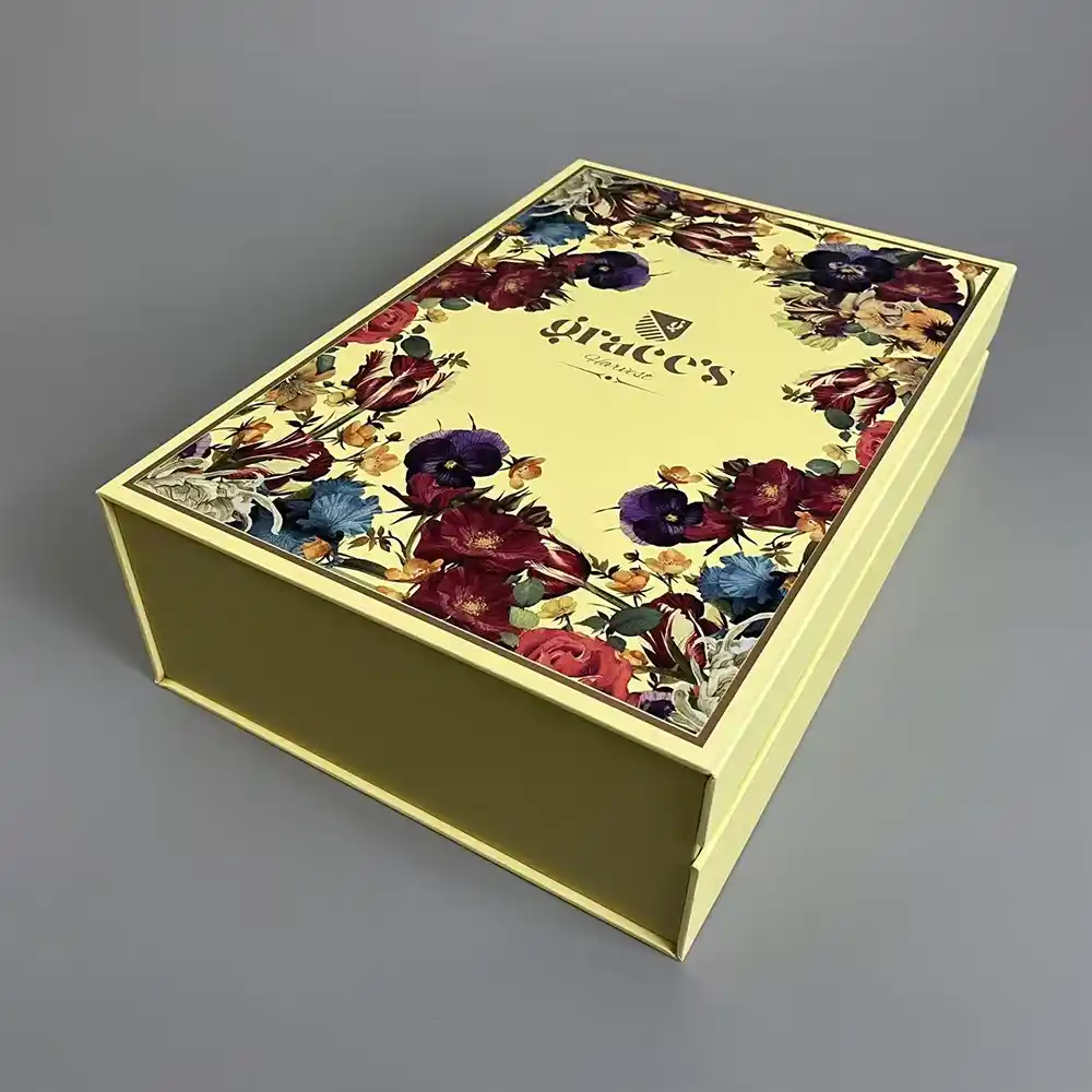 Closed gold magnetic wine gift box with floral printed lid design.
