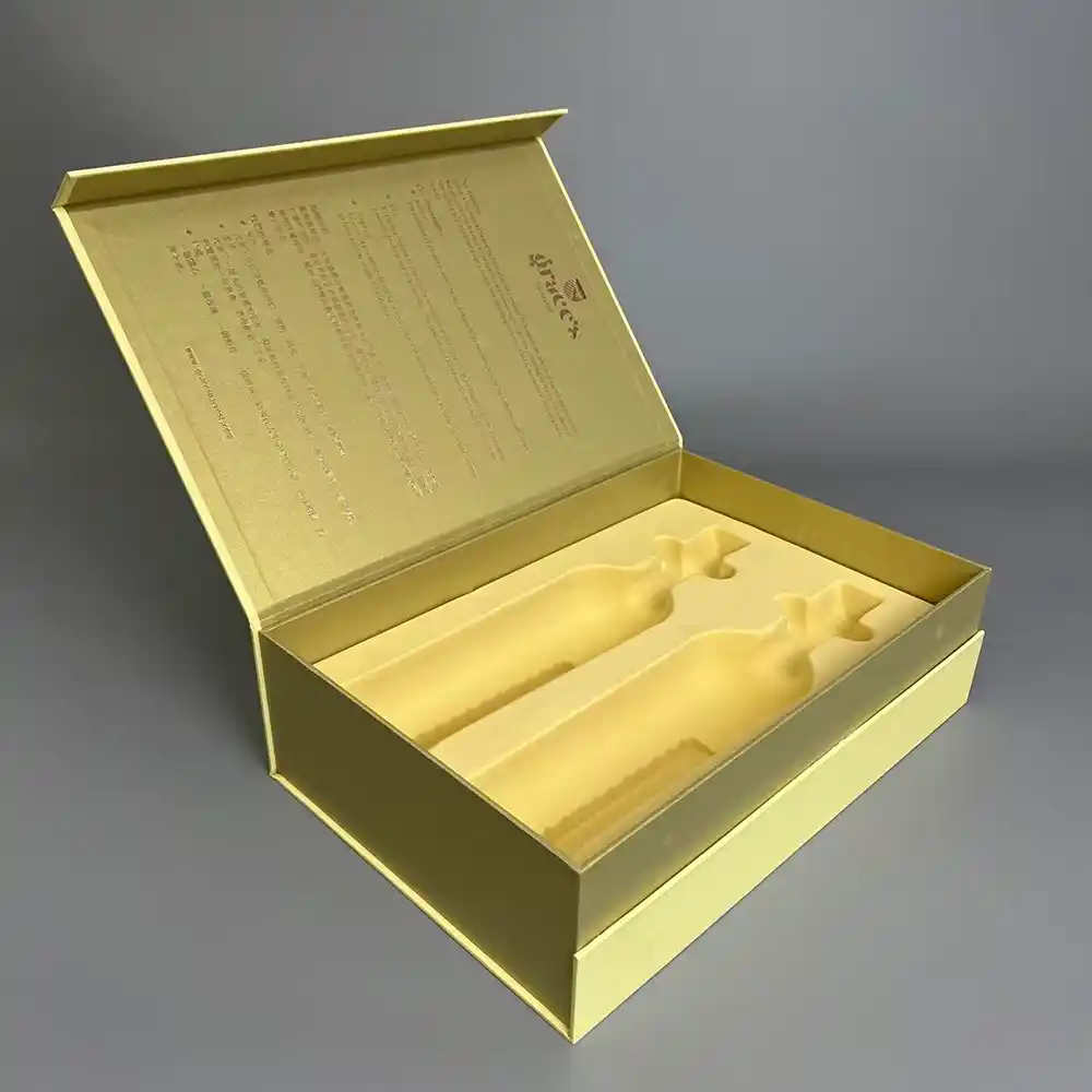 Open gold flip-top rigid wine gift box with dual bottle insert.