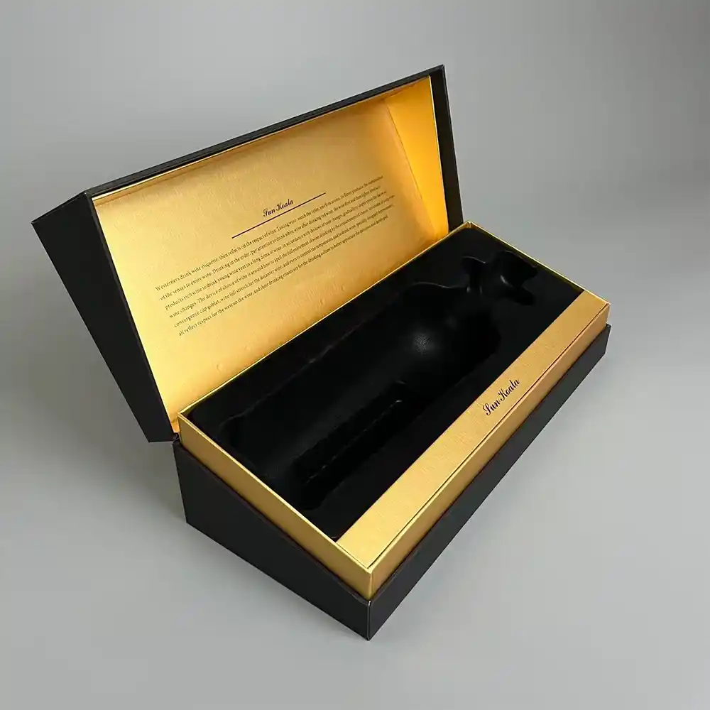 Open black flip-top wine box with gold interior and custom bottle insert.