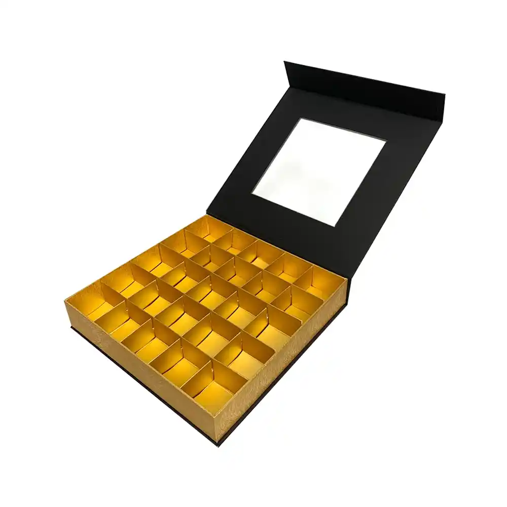 Black and gold magnetic chocolate box with clear window and multiple compartments.