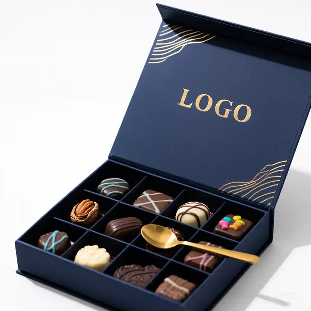 Luxury navy blue magnetic chocolate box with gold logo and compartments.