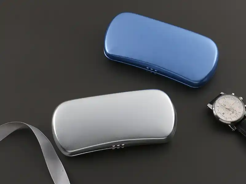 Metal eyeglass cases in silver and blue with smooth glossy finish