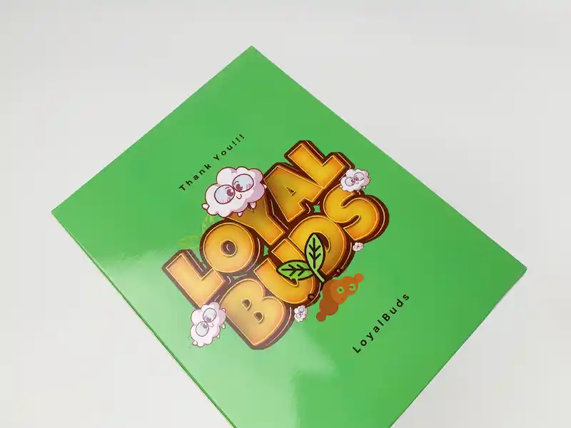 Glossy laminated green paper box with colorful Loyal Buds design