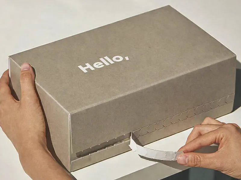 Kraft mailer shipping box with white logo and tear-strip zipper