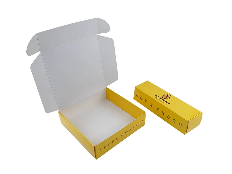 Yellow food-grade mailer box with open lid and matching printed sleeve box