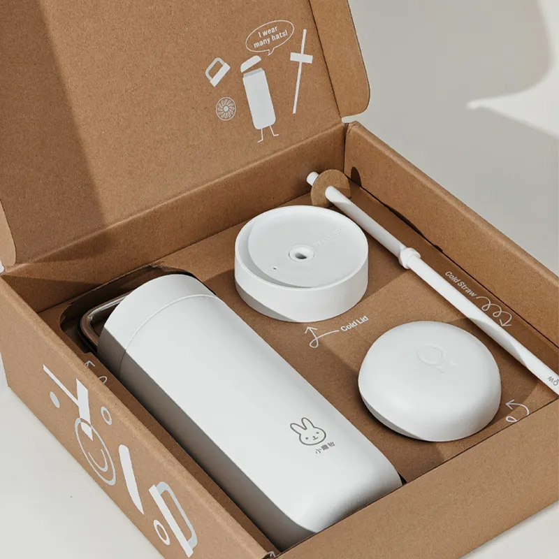 White thermos cup set in a kraft mailer box with custom insert for lid and straw accessories
